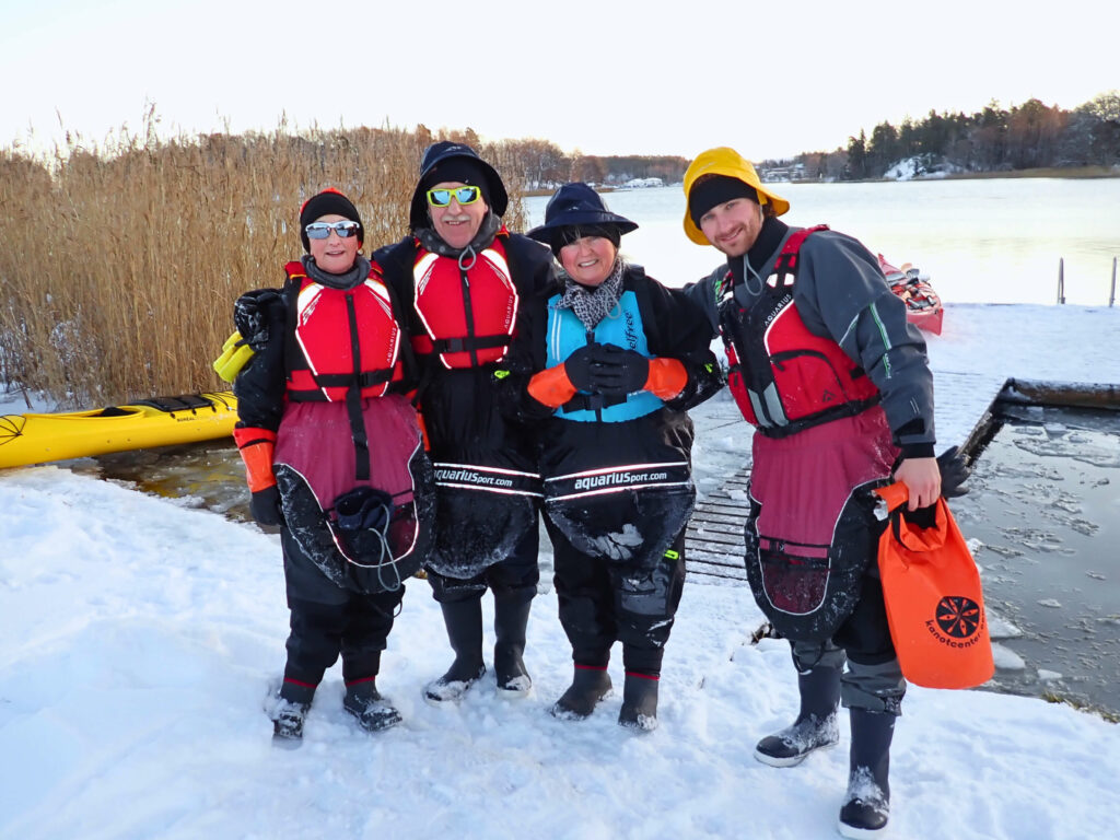 Family kayaking together in a winter landscape