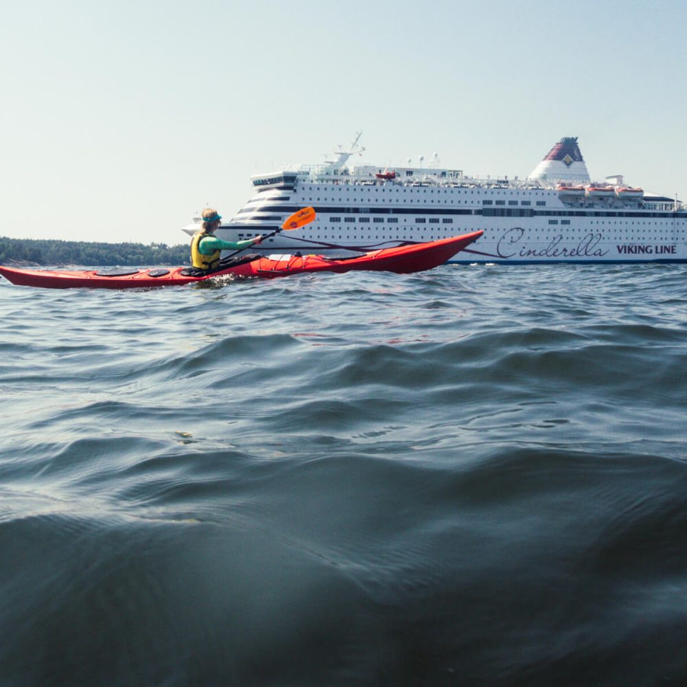 Paddling past towering ships in our kayaks, feeling small against the vastness of the sea