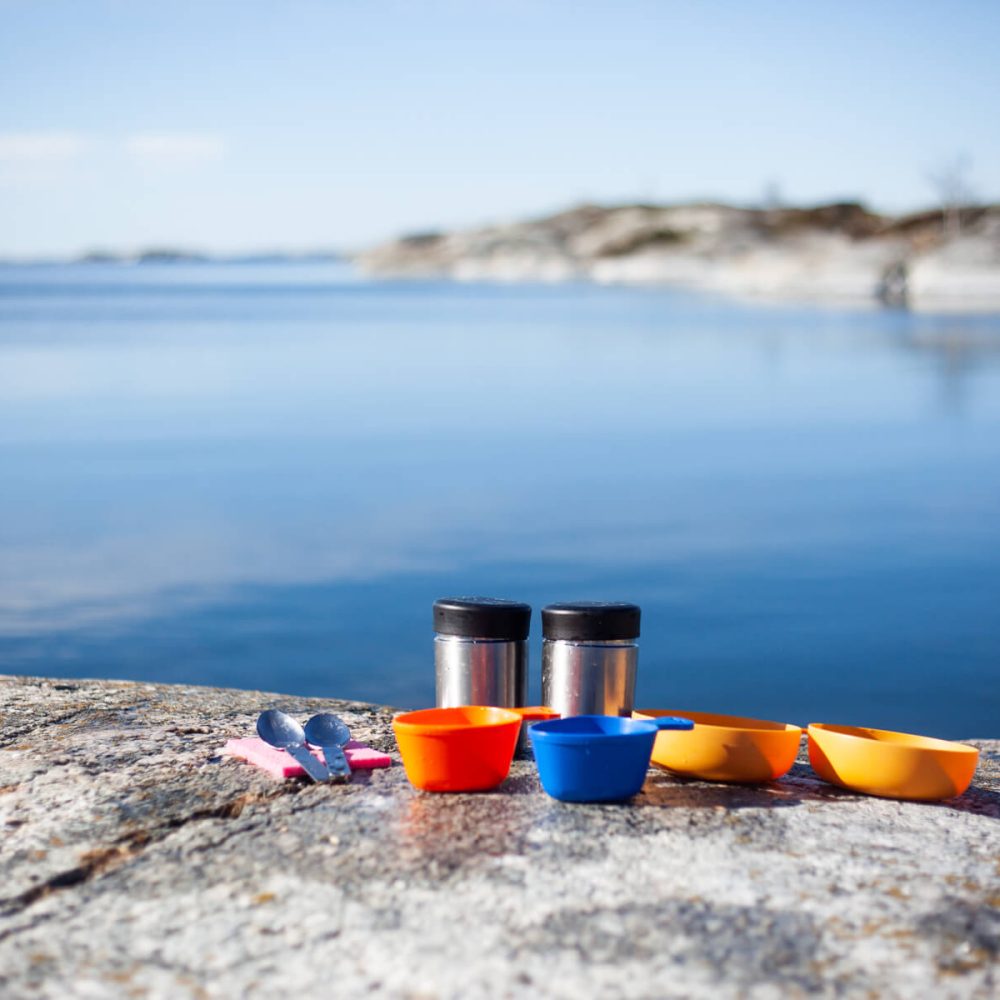 Clean Dishes at the Campsite with a Stunning View of Rocks and Sea