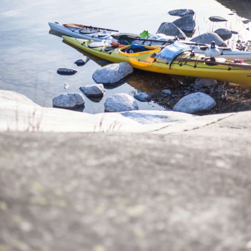 Kayak by the Shore, Sunlit Rocks, Calm Waters: Archipelago Serenity