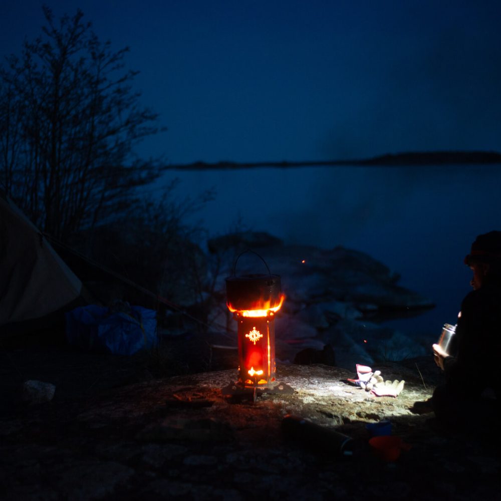 Preparing a meal by the campfire after a day of kayaking