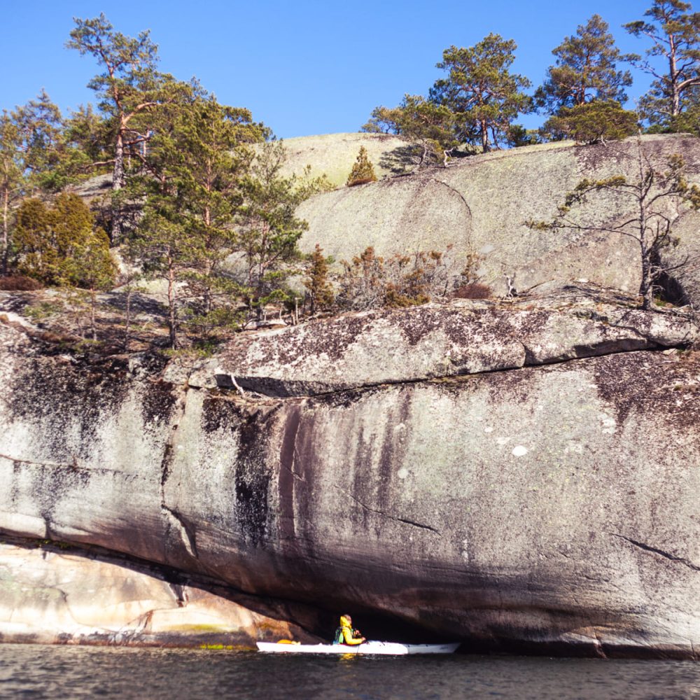 Under the Towering Cliff: A Small Kayak Explores the Waters Below