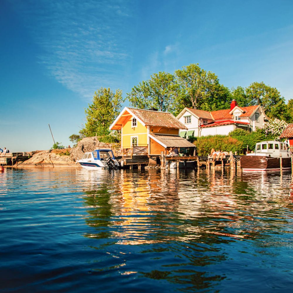 The vibrant, picturesque houses of Vaxholm line the waterfront, creating a colorful and charming sight