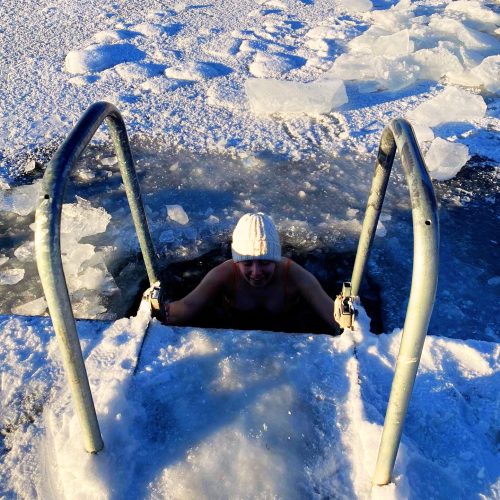 Person enjoying a cold sea dip after a sauna in the Stockholm Archipelago